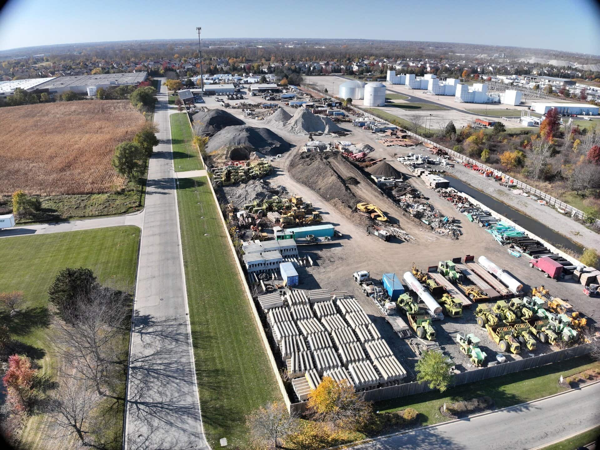 Aerial view of a construction site showcasing heavy machinery, building materials, and ongoing comme.